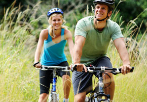 man and woman riding bikes outdoors