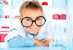 Cute boy is making science experiments in a laboratory.